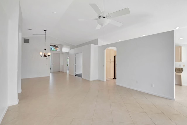 empty room with light tile patterned flooring, visible vents, vaulted ceiling, arched walkways, and ceiling fan with notable chandelier