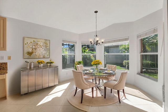 dining room with light tile patterned floors, vaulted ceiling, and a chandelier