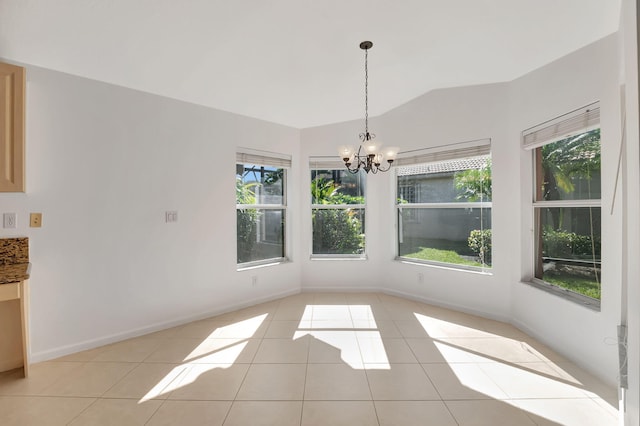 unfurnished dining area featuring a chandelier, baseboards, light tile patterned flooring, and vaulted ceiling