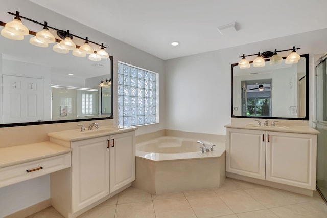 full bath with tile patterned floors, a garden tub, a stall shower, and a sink