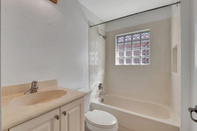 full bathroom featuring toilet, tiled shower / bath combo, and vanity