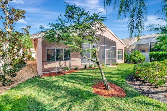 view of front of house featuring stucco siding and a front lawn