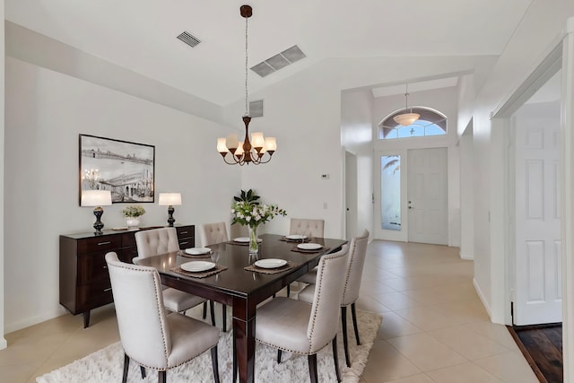 dining area featuring light tile patterned floors, visible vents, and a chandelier