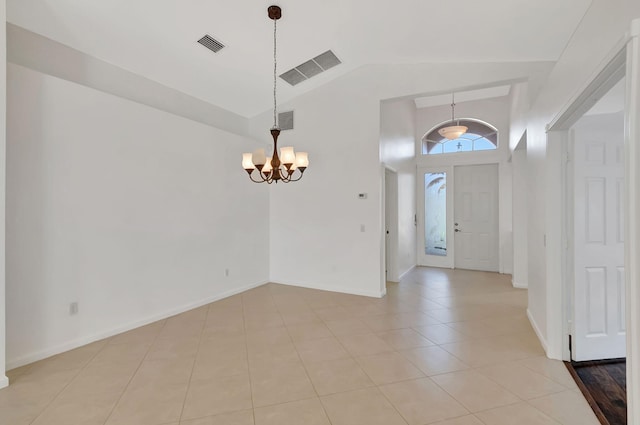 entryway featuring light tile patterned floors, visible vents, high vaulted ceiling, and a chandelier