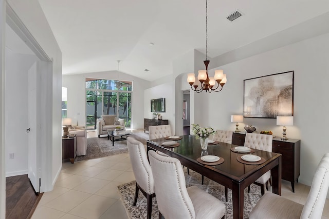 tiled dining area featuring lofted ceiling