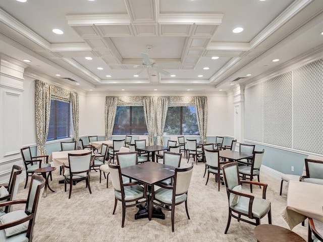 carpeted dining room with ceiling fan, coffered ceiling, beamed ceiling, and crown molding