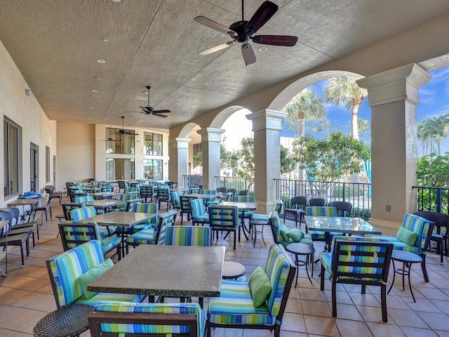 view of patio featuring fence, ceiling fan, and outdoor dining area