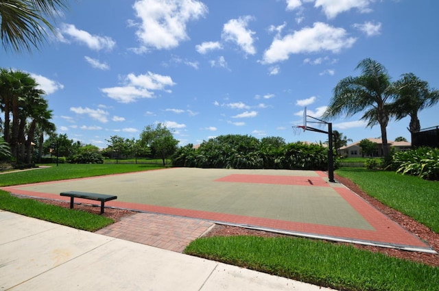 view of basketball court with a lawn