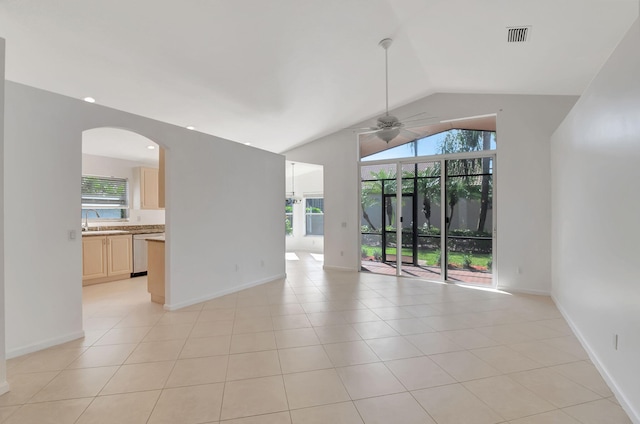 unfurnished room featuring a sink, light tile patterned floors, ceiling fan, visible vents, and lofted ceiling