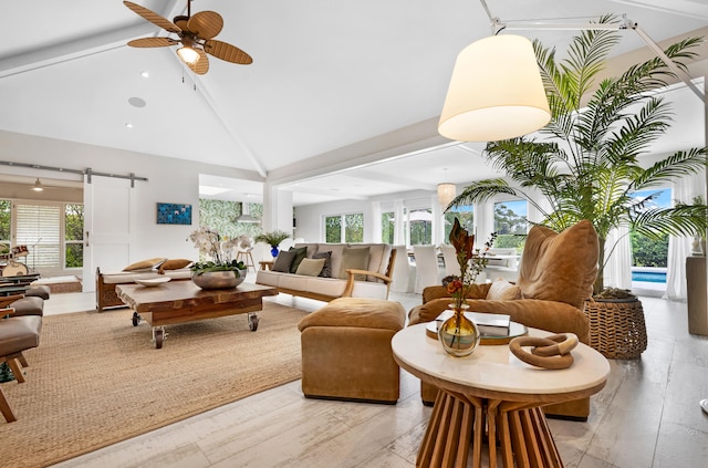 living room featuring beam ceiling, a barn door, light hardwood / wood-style flooring, and ceiling fan