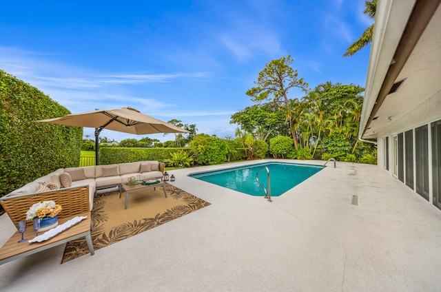 view of pool with a patio area and an outdoor living space