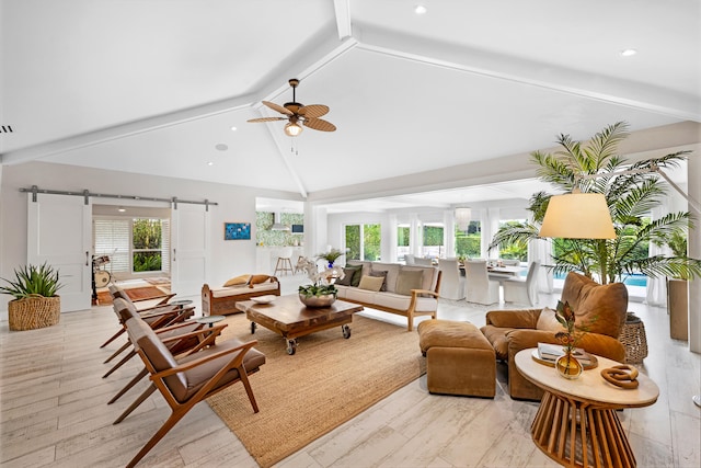 living room with high vaulted ceiling, beamed ceiling, light wood-type flooring, and a barn door