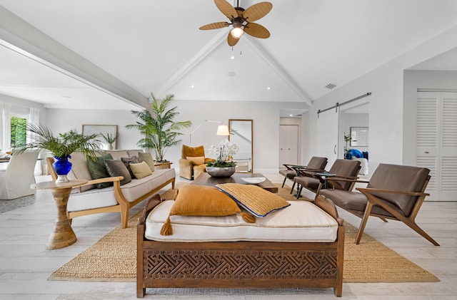 living room featuring a barn door, vaulted ceiling with beams, light hardwood / wood-style floors, and ceiling fan