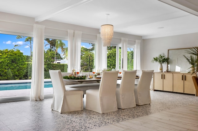 dining area with beamed ceiling, light hardwood / wood-style flooring, and a notable chandelier