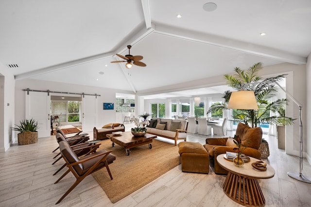 living room featuring beam ceiling, high vaulted ceiling, light hardwood / wood-style flooring, and a barn door