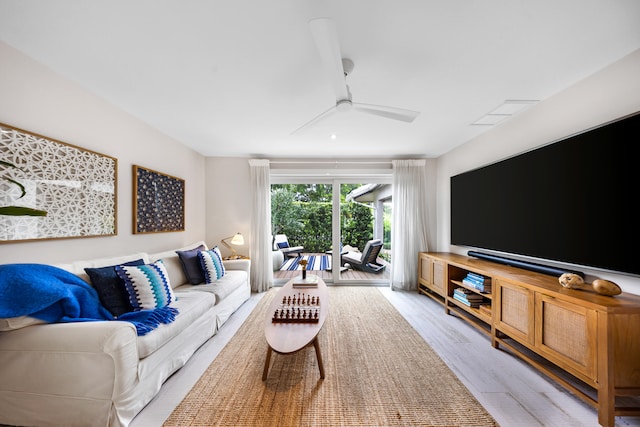 living room with light wood-type flooring and ceiling fan