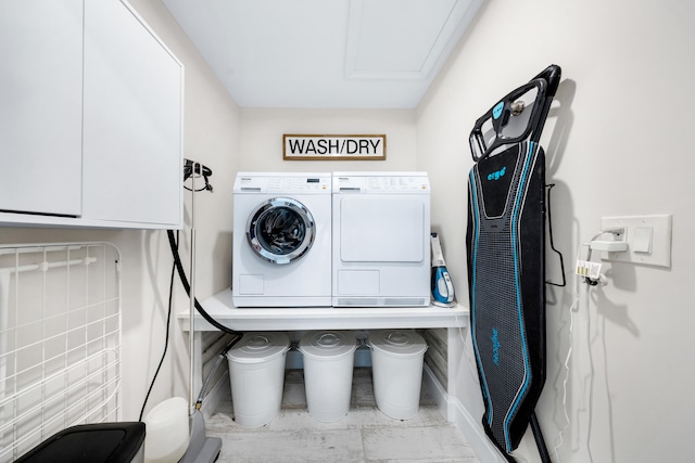 laundry room with independent washer and dryer and cabinets