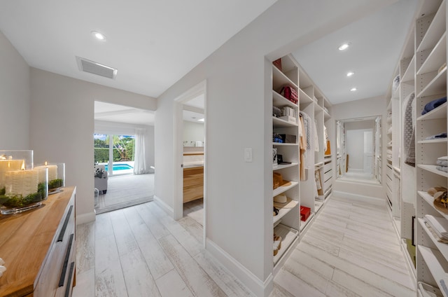 corridor with light hardwood / wood-style floors