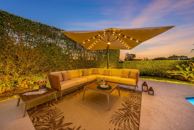 patio terrace at dusk featuring outdoor lounge area