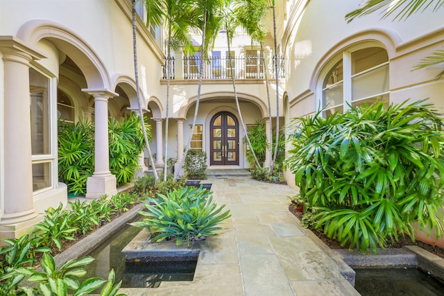 entrance to property featuring french doors and a balcony