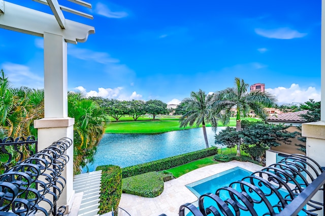 view of pool featuring a water view and a lawn