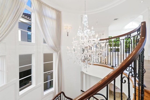 interior space with crown molding, an inviting chandelier, and hardwood / wood-style floors