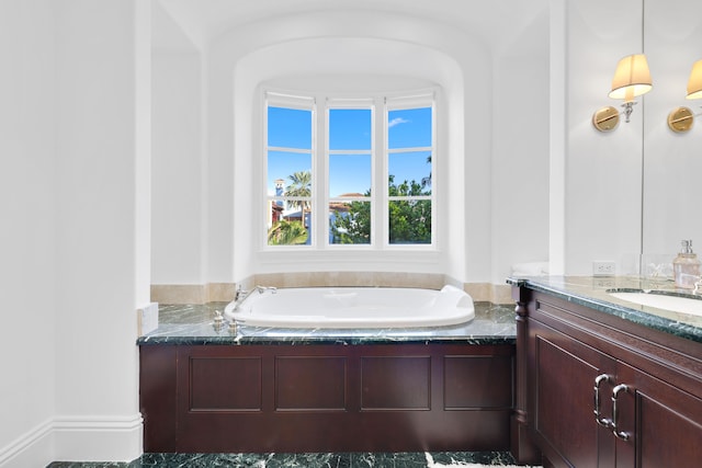 bathroom featuring vanity and a bath