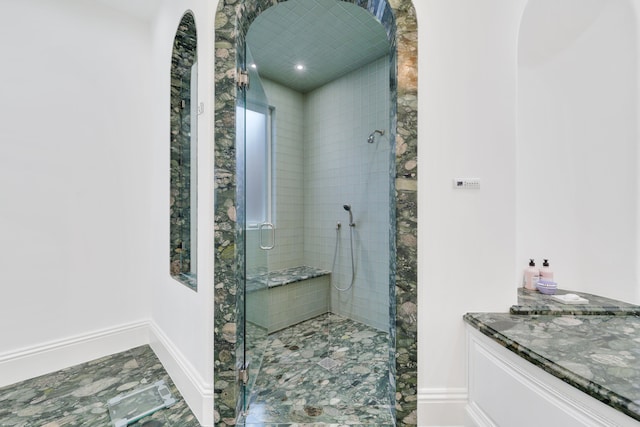 bathroom featuring vanity and a shower with shower door