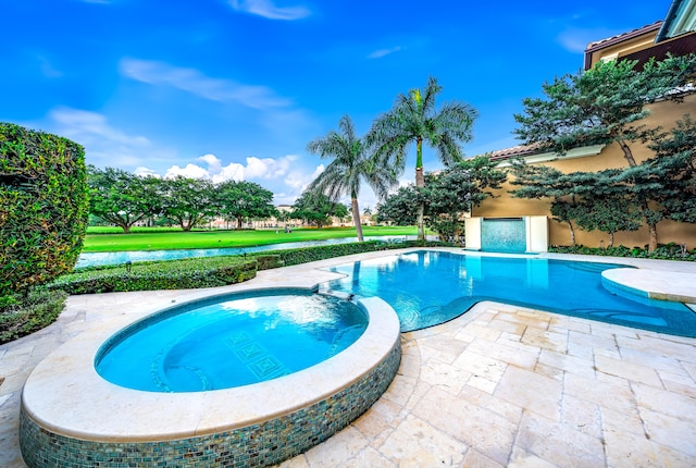 view of swimming pool featuring an in ground hot tub, a patio area, and a lawn