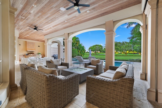 view of patio with an outdoor living space and ceiling fan