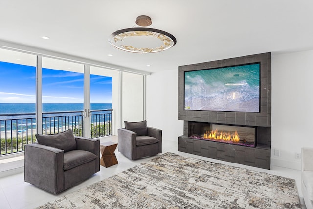 living area with a tile fireplace