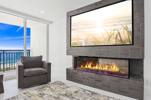 living area with a tiled fireplace