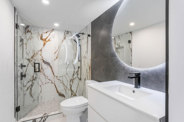 bathroom with decorative backsplash, tile walls, toilet, a shower with shower door, and vanity