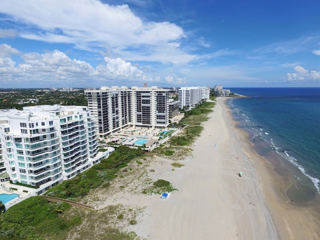 drone / aerial view with a water view and a beach view