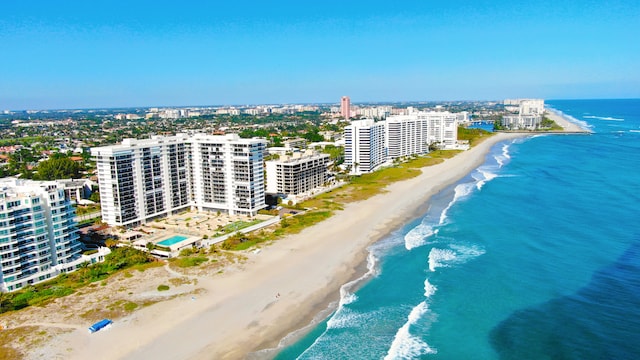 bird's eye view featuring a view of the beach and a water view