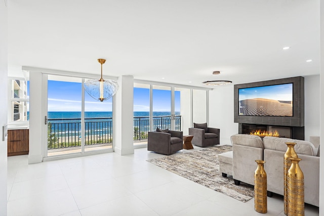 living room featuring a wall of windows and a fireplace