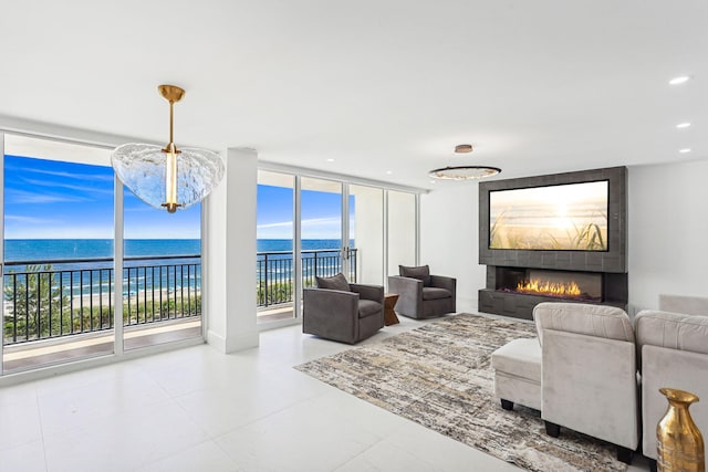 living room featuring a wall of windows and a fireplace