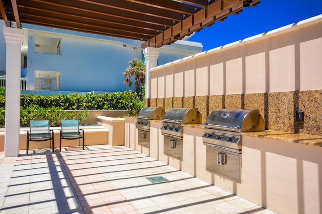 view of patio with area for grilling and a grill