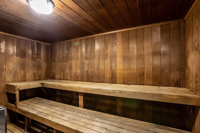 view of sauna / steam room with wooden walls and wooden ceiling