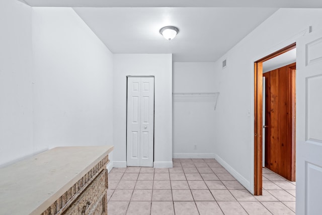 interior space featuring a closet and light tile patterned floors