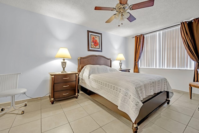 tiled bedroom with a textured ceiling and ceiling fan