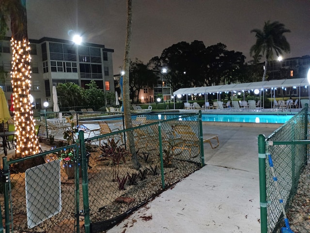 pool at night with a patio