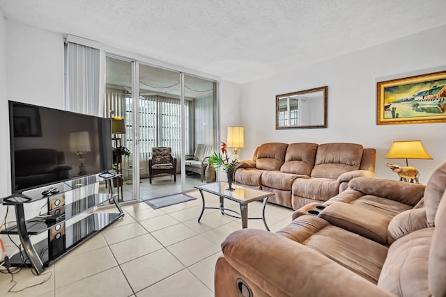 tiled living room featuring a textured ceiling