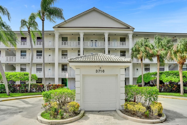 view of front of house featuring a balcony and a garage