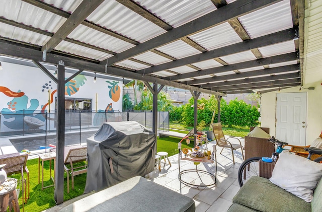 view of patio / terrace with a pergola, grilling area, and a trampoline