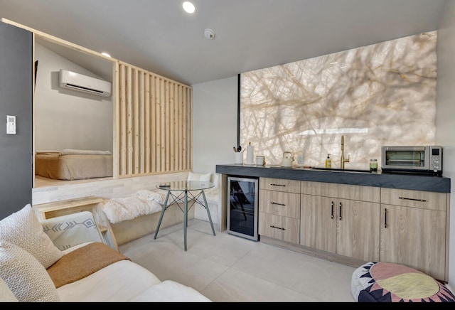 interior space with light brown cabinetry, sink, a wall unit AC, and beverage cooler