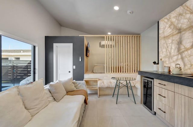 living room with lofted ceiling, wine cooler, and light tile patterned floors