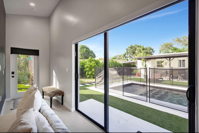 doorway to outside with light tile patterned floors and plenty of natural light