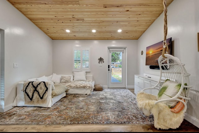 living room featuring hardwood / wood-style flooring, wooden ceiling, and vaulted ceiling