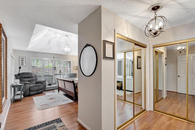 hallway featuring a textured ceiling and hardwood / wood-style flooring